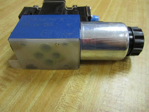 Directional control solenoid R978031711 2WE6Y62/EG24 N9DK24L2/62 24 VDC hydraulic valve, side view on wood surface