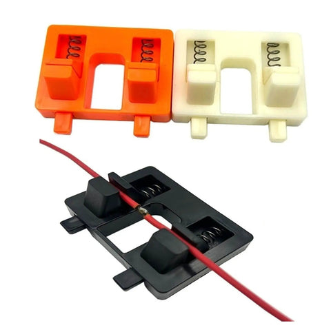 Three durable welding fixture brackets in orange, white, and black with springs, suitable for adjustable suction welding.