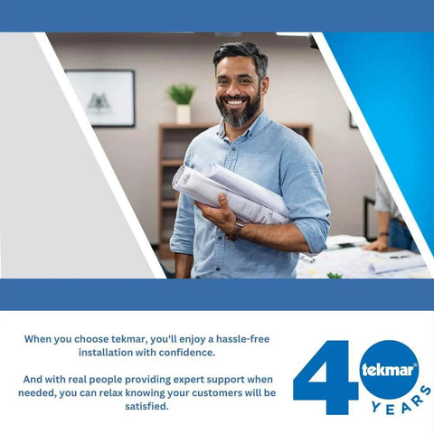 Smiling man holding blueprints in office, tekmar 40 years logo visible