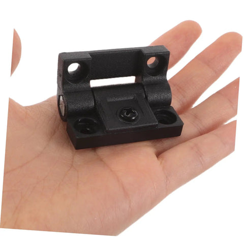 Plastic Cabinet Door Hinges Black Adjustable Torque Friction Positioning Stop shown on hand for scale