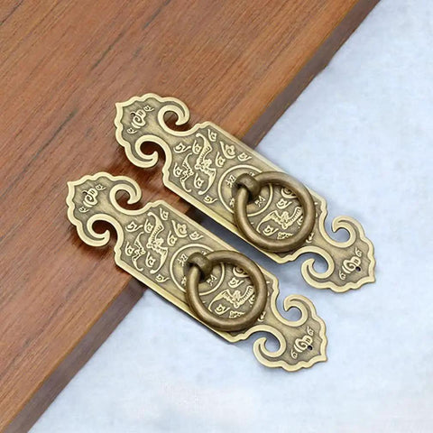 Two Pack Vintage Style Embossed Brass Drawer Pulls For Wardrobe Bookcase And Double Doors In Antique Bronze Finish on wood