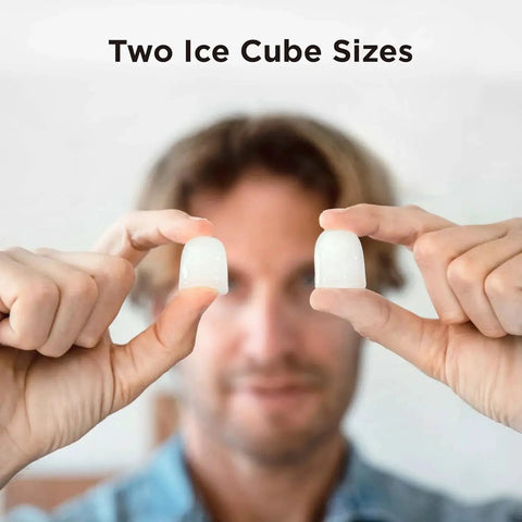 Person displaying two ice cube sizes from Countertop Ice Maker 9 Bullet Ice Cubes In 6 Minutes Self Cleaning With Scoop.