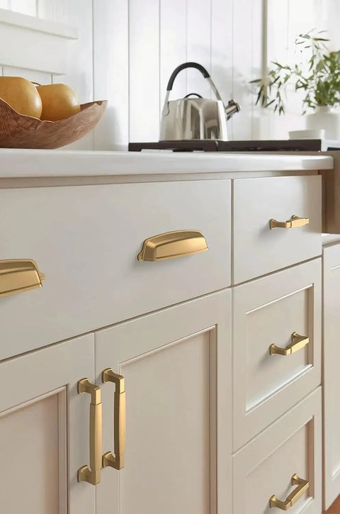 Champagne Bronze Cup Cabinet Pull 5 1 16 Inch Center To Center 6 3 8 Inch Overall Length Stature Collection Drawer Pull installed on cabinets