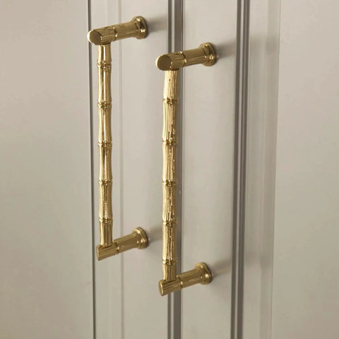 Gold Brass Bamboo Shape Cabinet Handles Set, Antique Brushed Copper Finish, installed on a cabinet with screw details visible