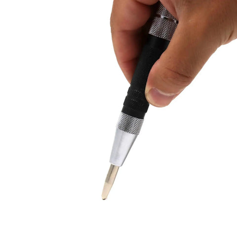 Close-up of a hand holding Automatic Center Punch Beefy 6 Inch Spring Loaded Center Hole Punch for metal and wood.