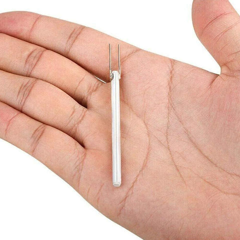 Ceramic soldering iron heater element, white tube with two metal leads, held in palm