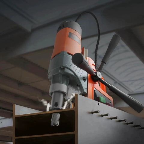 Portable Magnetic Drill Press With 1300W Copper Motor 810 RPM 1.57 Inch Boring Capacity drilling into a metal beam in an industrial setting.