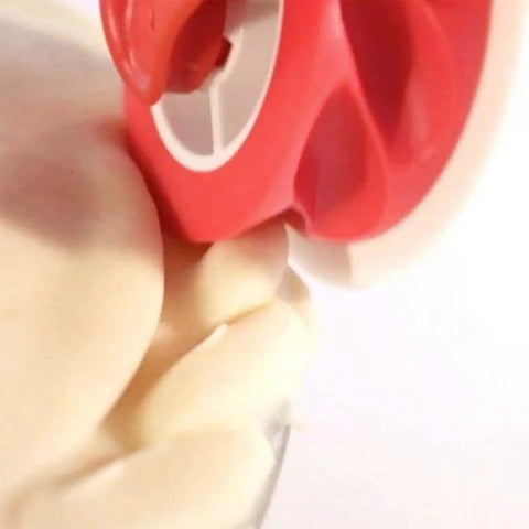 Close-up of Pie Crust Cutter With Wave And Twist Crinkle Design Pastry Wheel cutting dough with ergonomic handle