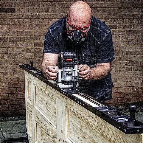 Person using All-In-One Adjustable Door Hinge Jig Installation Kit For 2 Ft 6 In To 9 Ft Doors with router bit in workshop