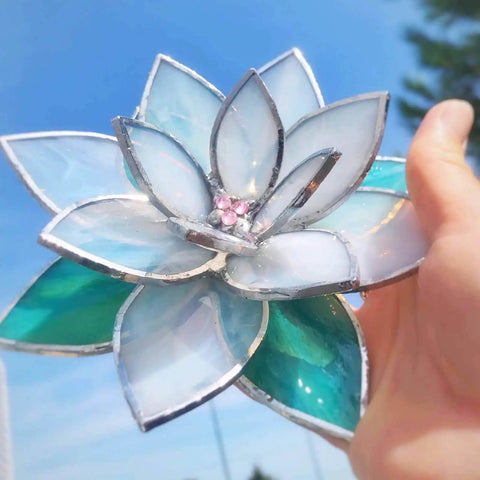 Close-up of Four Layer Stained Glass Succulent Soldering Jig Kit With 3D Flower Bloom held in hand against blue sky.