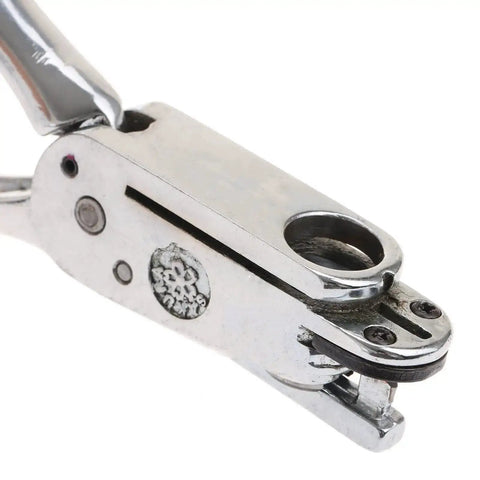 Close-up of handheld slot and 13mm round hole punch tool, metal body, used for ID cards, badges, PVC tags, leather, and paper crafts.