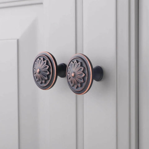 Oil Rubbed Bronze Flower Shaped Cabinet Knob Set 12 Pack For Cabinets And Drawers installed on white cabinet doors