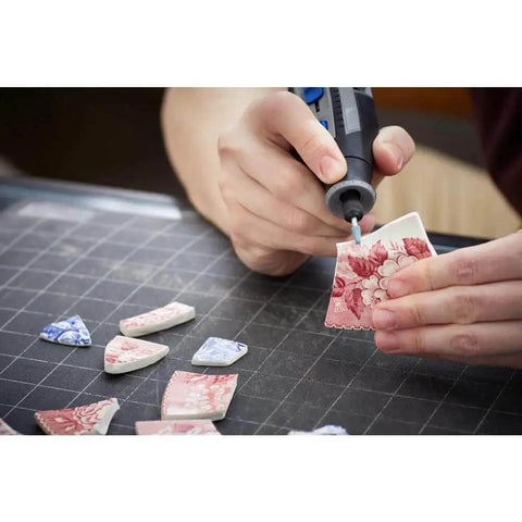 Person using Dremel rotary tool from Versatile 11 Piece Carving And Engraving Micro Accessory Kit For Dremel Rotary Tools With Reusable Case