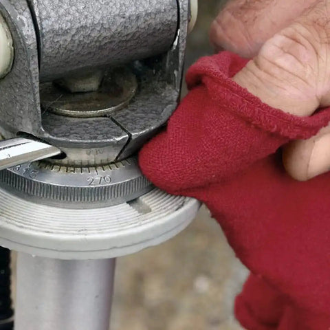 Red gloved hand using 150 Pack Cotton Shop Towels Rags 14x12 Inches Absorbent, Reusable Cleaning Rags For Auto Shops on machinery.