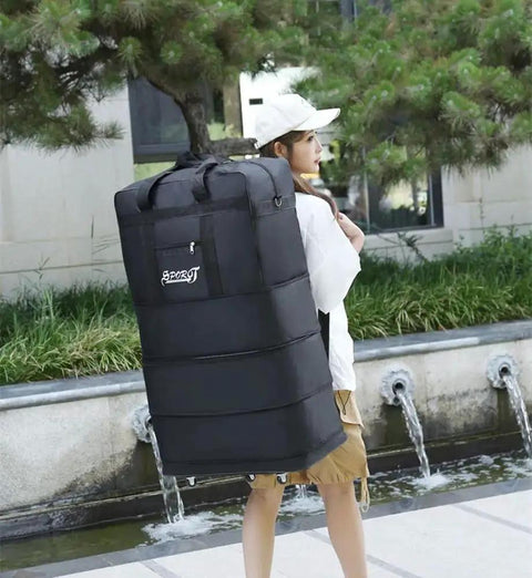 Person carrying Expandable Extra Large Travel Duffel Bag With Six Wheel Spinner, Waterproof Oxford Fabric, outdoors