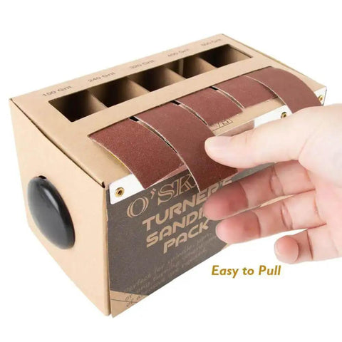 Hand pulling sanding strip from Sanding Strip Kit With Dispenser, 5 Grit Range 150 240 320 400 600 Rolls For Woodturners.