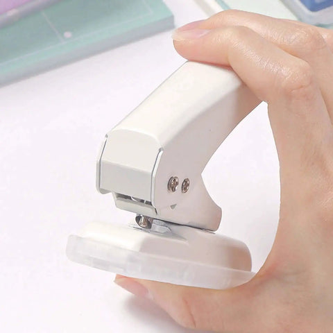 Hand holding Portable Workhorse One Hole Punch Handheld Metal Hole Puncher With 40 Sheet Paper Capacity for crafting