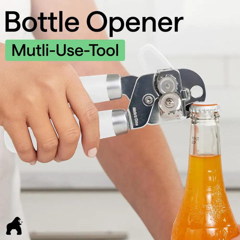 Heavy Duty Stainless Steel Can Opener With Smooth Edge And Bottle Openers Soft Comfortable Handle Oversized Turn Knob No Fuss One Handed Opening US Designed Multifunction Kitchen Tool In White Gorilla Grip being used to open a bottle