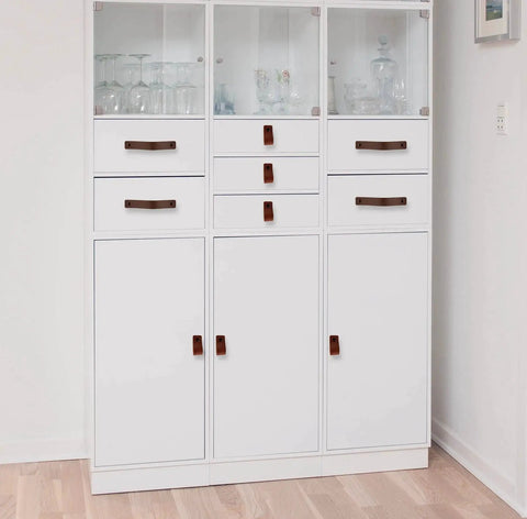 Leather Furniture Handles Set Two Pieces Cognac Leather Drawer Pulls on white cabinet in modern home