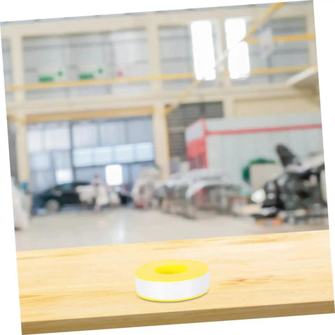 High Temp PTFE Sealing Tape Thread Sealant For Water Leaks displayed on a wooden table with a blurred industrial background