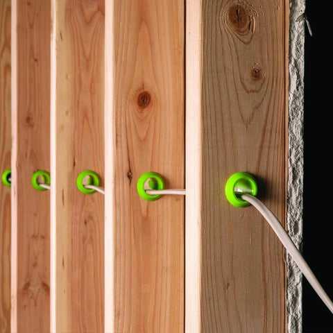 EZ Guard single stud electrical wire protector 5-pack; green plastic grommets through wooden studs with white wire