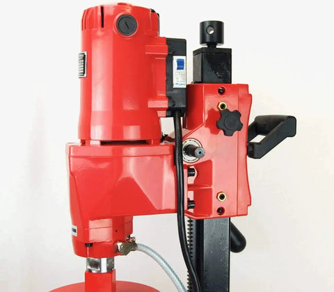 Close-up of Pro Grade Heavy Duty Concrete Core Drill Package With 8 Inch Wet Coring Bits, showing drill and stand in red finish.