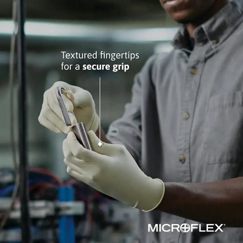 Person wearing Diamond Grip MF300 Disposable Latex Gloves With Textured Fingertips demonstrating secure grip on a tool