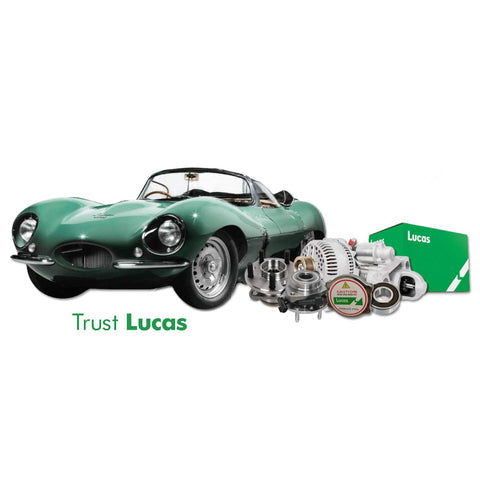 Vintage green car with Lucas automotive parts displayed, including alternator and packaging.
