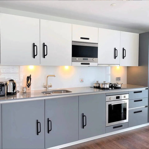 Modern kitchen with matte black cabinet handles on white and gray cabinets, showcasing 12 Pack Matte Black Cabinet Handles Aluminum Drawer Pulls.