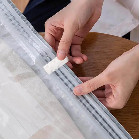 Person sealing vacuum bag with 30 Pack Vacuum Storage Bag Sealing Clips Quick Snap Zipper Grips Reusable Bag Sealer