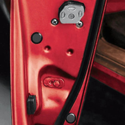 Close-up of red car door with black flush mount plastic hole plug from Fifty Piece Flush Mount Plastic Hole Plug Set For Auto Body And Sheet Metal.
