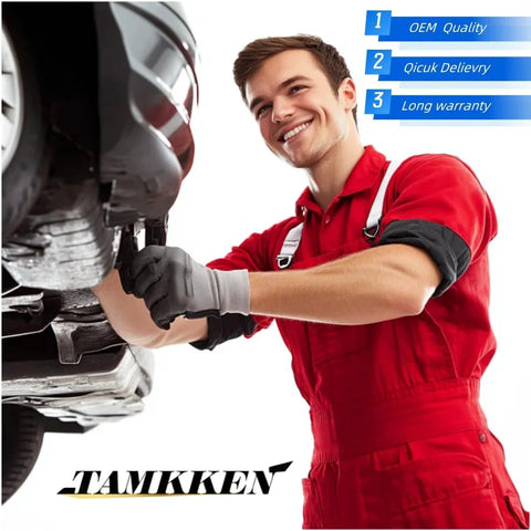 Mechanic in red coveralls working underneath a car on a lift, focusing on vehicle maintenance and repair