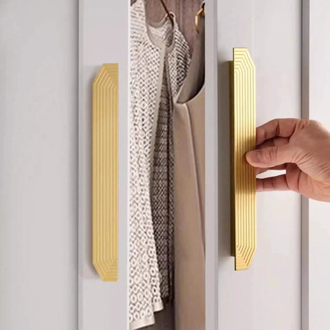 Hand using Brushed Gold Cabinet Pulls 9.75 Inch Polygon Drawer Handles 2 Pack With Screws on a white cabinet door