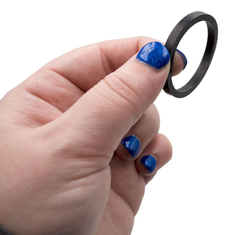 Water heater element gasket ring, black rubber, small diameter held between fingers.