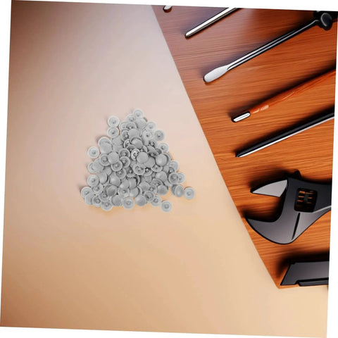 Pile of grey screw cover caps with tools, 500 pack durable plastic thread protectors for cabinets furniture and construction.