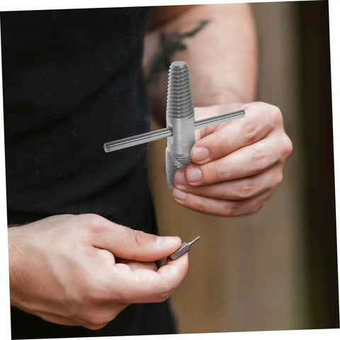 Close-up of hands holding Dual Head Water Pipe Extractor And Broken Screw Remover Tool For Stripped Screws Valves And Bolts Heavy Duty Repair Kit