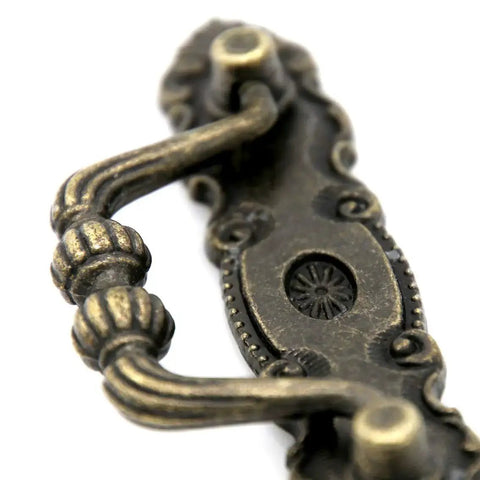 Close-up of Set Of Four Vintage Brass Bail Pulls For Drawers Cabinets And Dressers With Antique Distressed Finish Drop Handle Design