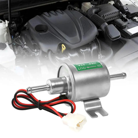 12V Heavy Duty Inline Fuel Pump For Lawn Mowers And Cars Universal Low Pressure Transfer Pump For Gas And Diesel Engines Built From Copper Clad Aluminum Corrosion Resistant Durable Performance Ready Silver Finish shown in front of car engine