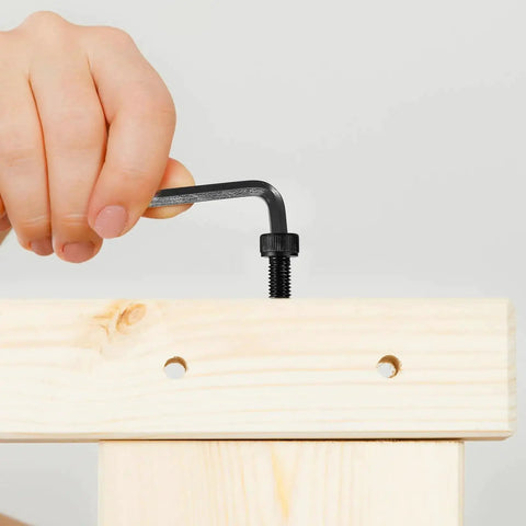 Person using hex key with All In One 1680 Pcs Metric Hex Bolts And Nuts Set M2 To M5 With Washers And Black Finish on wooden board