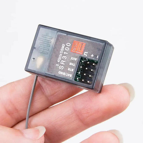 Close-up of SR3100 2.4GHz DSM2 3 Channel Surface Receiver for DX3R DX4C DX5C Transmitters in hand