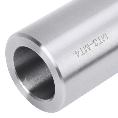MT3-MT4 taper drill sleeve adapter, silver steel, through bore — close-up side view.