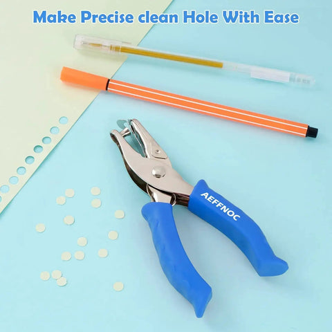 One Hole Paper Punch With Soft Grip Handle One Quarter Inch Hole Puncher For Crafts And Scrapbooks With Mess Tray Six Sheets Capacity Durable Metal Construction Blue shown with punched paper and pens.