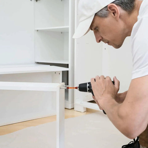 Man using Pro Grade 20 Piece Hex Bit Drill Set In S2 Steel With Magnetic Tips to assemble white furniture.