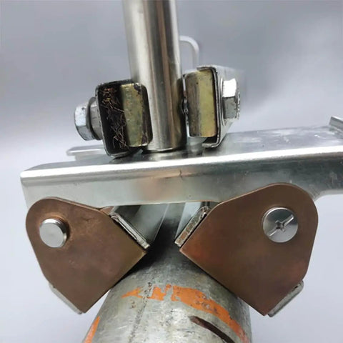 Close-up of Hi-Temp Grounding Magnetic V-Pad With Pure Copper Contact For Welding Fixtures And Grounding, attached to metal pipe