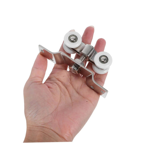2 Pack Stainless Steel Sliding Door Pulleys With Silent Nylon Rollers, shown held in hand, highlighting size and material