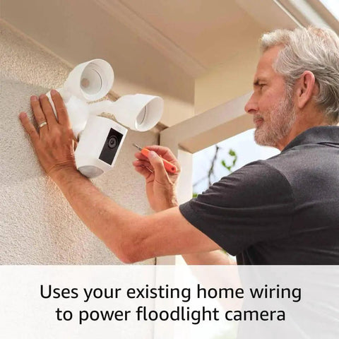 Floodlight Cam Wired Plus Outdoor Security Camera With 1080p HD And Motion Zones being installed by man on exterior wall