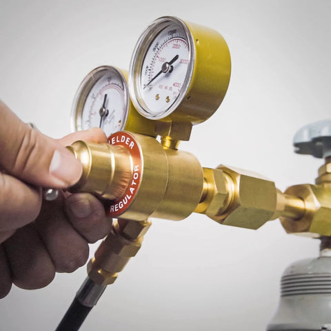 Close-up of Argon CO2 Welding Regulator with 8.2 ft hose for MIG and TIG welding, featuring 0-4000 PSI inlet gauge and dual outlet gauges.