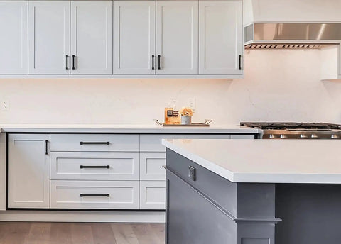 Matte Black 5 Inch Cabinet Pulls 10 Pack With 128mm Hole Centers installed on modern gray kitchen cabinets and island.