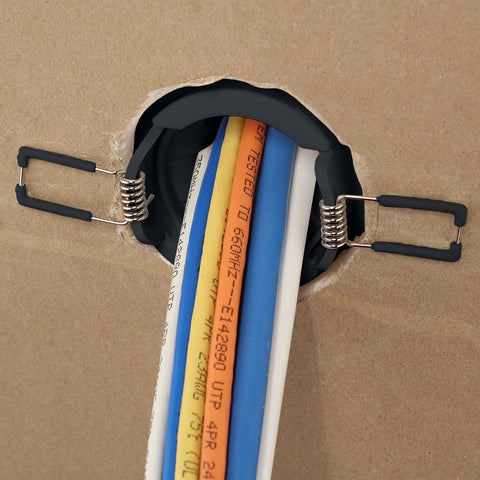 Construct Pro Speedy Spring-Lock cable pass-through port, 2 in ID, black, installed in panel with cables