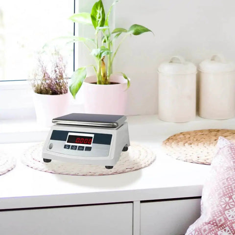 Digital kitchen scale on countertop with display, surrounded by plants and jars, demonstrating usage of 4 Pack Replacement Scale Feet For Electronic Platform Scales With Shock Absorber Design, Universal 1.37 Inch Stable, Rock Solid Heavy Duty Durable Feet For Industrial And Scientific Scales, Improves Balance And Accurate Weighing.